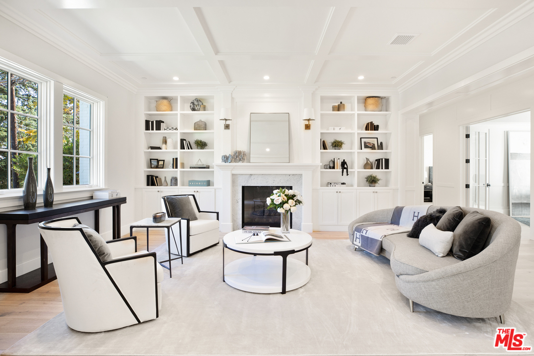 829 Greentree Road Pacific Palisades, CA 90402 - Photo 8 of 50 a living room with furniture and a fireplace