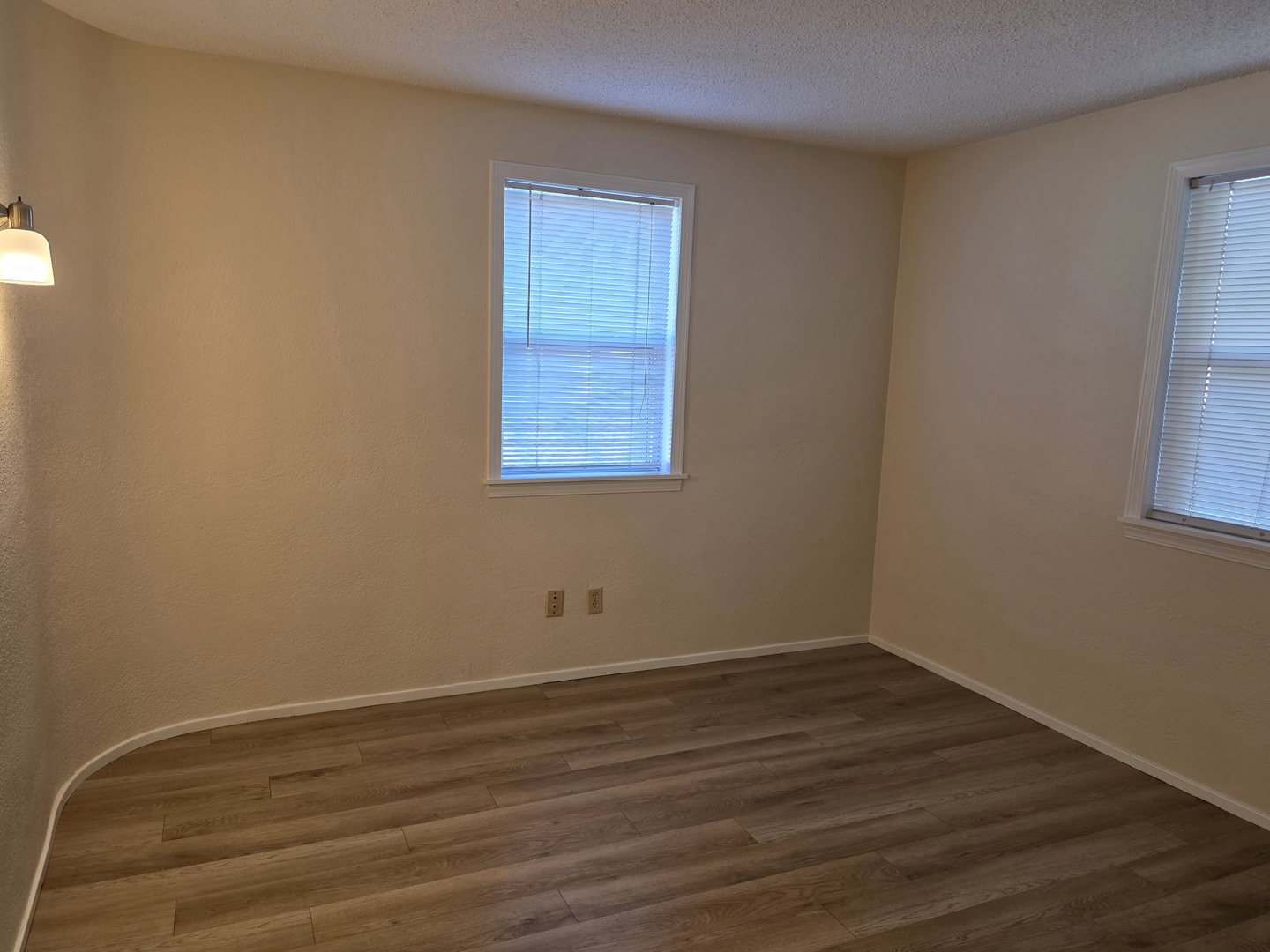 311 Maple Street Prophetstown, IL 61277 - Photo 4 of 9 a view of an empty room with wooden floor and a window