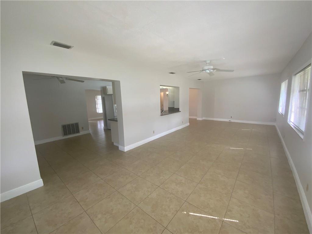 7104 Northwest 70th Street Tamarac, FL 33321 - Photo 12 of 30 wooden floor in an empty room with a window