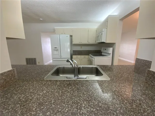 a large bathroom with a tub and chandelier
