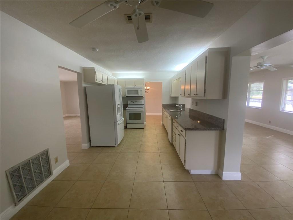 7104 Northwest 70th Street Tamarac, FL 33321 - Photo 14 of 30 a large bathroom with a tub and chandelier