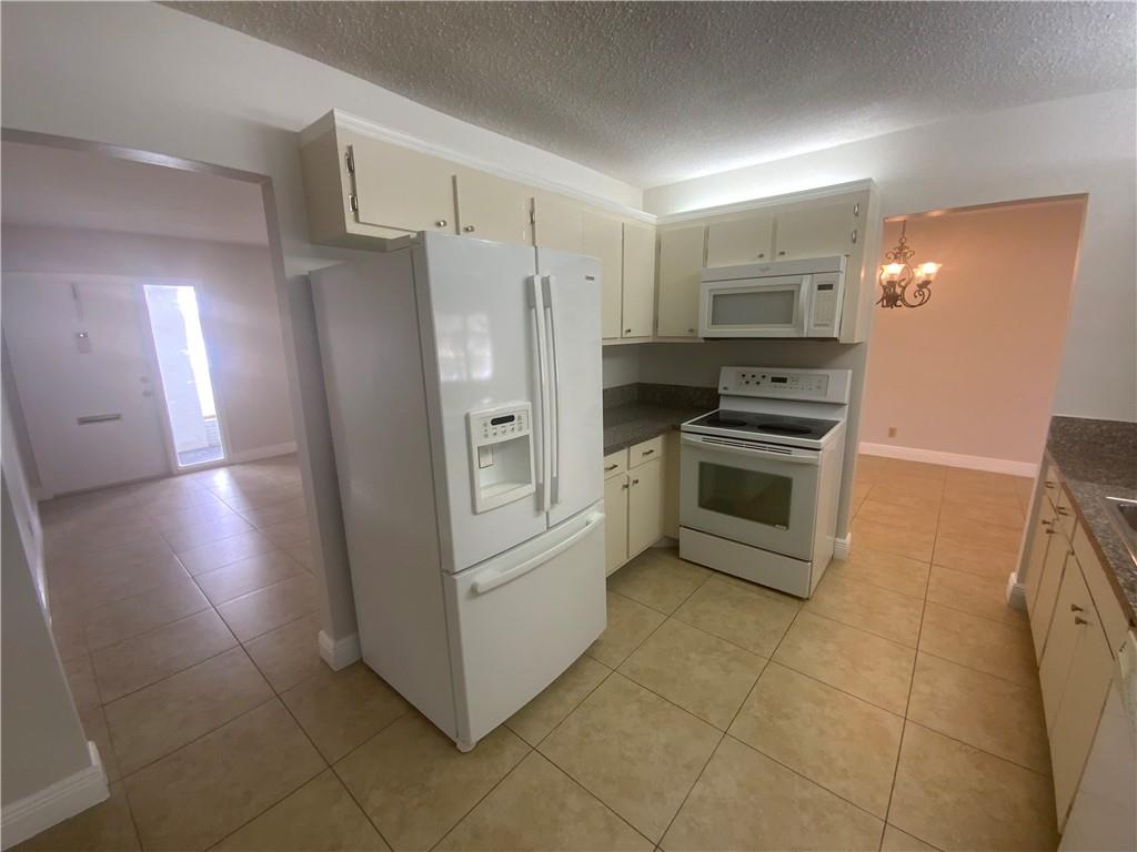 7104 Northwest 70th Street Tamarac, FL 33321 - Photo 15 of 30 a kitchen with stainless steel appliances a refrigerator stove and sink