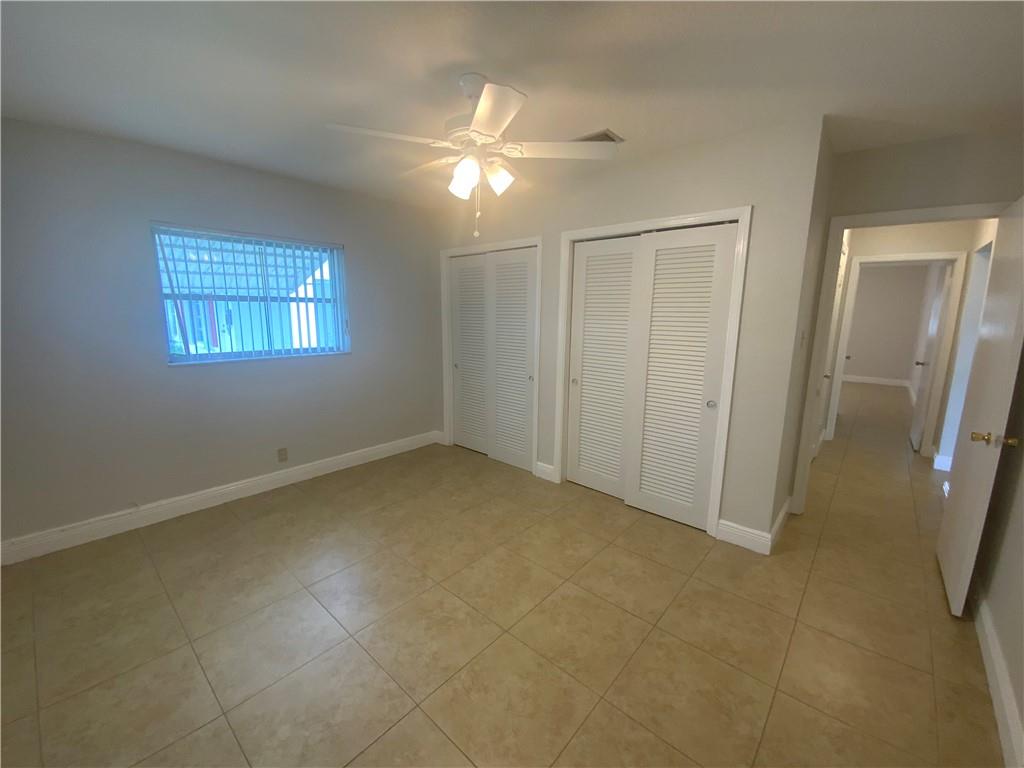7104 Northwest 70th Street Tamarac, FL 33321 - Photo 19 of 30 an empty room with windows and entrance