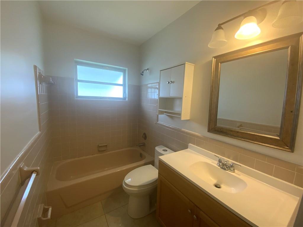 7104 Northwest 70th Street Tamarac, FL 33321 - Photo 20 of 30 a bathroom with a sink a toilet and shower