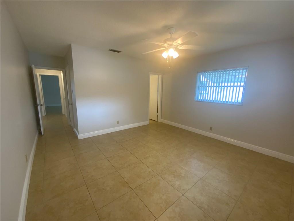7104 Northwest 70th Street Tamarac, FL 33321 - Photo 22 of 30 an empty room with windows and closet