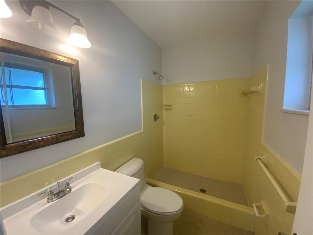 7104 Northwest 70th Street Tamarac, FL 33321 - Photo 24 of 30 a bathroom with a sink a toilet and shower