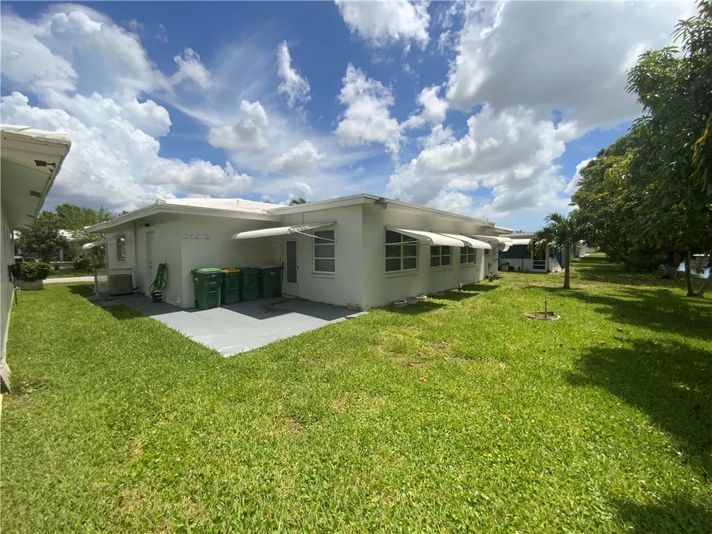 7104 Northwest 70th Street Tamarac, FL 33321 - Photo 30 of 30 a view of a house with a big yard and a large tree