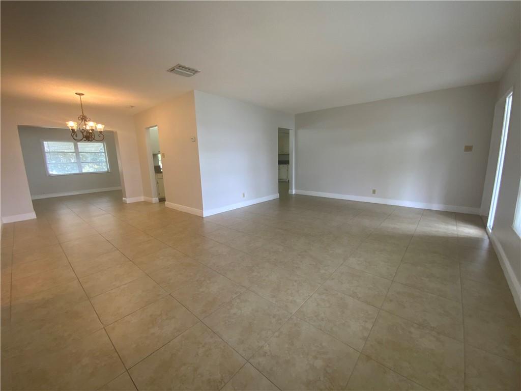 7104 Northwest 70th Street Tamarac, FL 33321 - Photo 6 of 30 a view of an empty room with glass door and a window