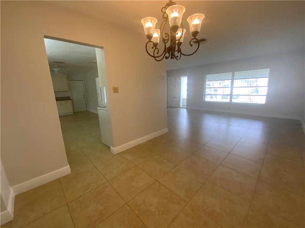 7104 Northwest 70th Street Tamarac, FL 33321 - Photo 7 of 30 wooden floor in a hall with a window