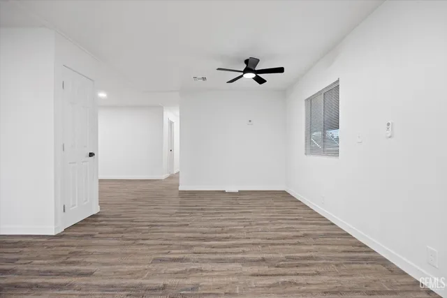 a view of empty room with wooden floor