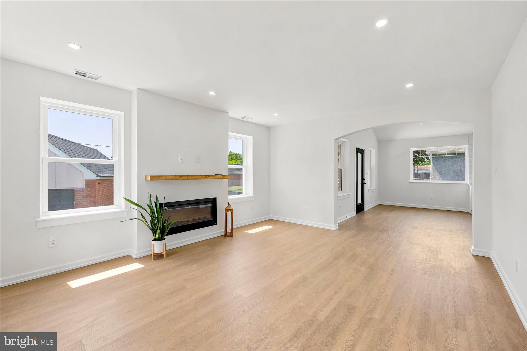 8 James Road Broomall, PA 19008 - Photo 15 of 35 a view of empty room with a fireplace and wooden floor