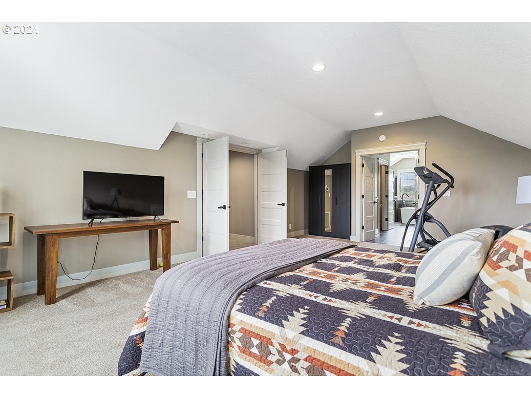 5360 Southeast Chase Road Gresham, OR 97080 - Photo 27 of 48 a bedroom with a bed and a flat screen tv