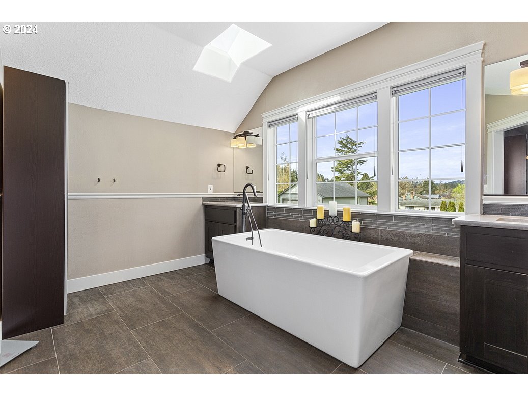 5360 Southeast Chase Road Gresham, OR 97080 - Photo 31 of 48 a living room with a large window a table and chairs