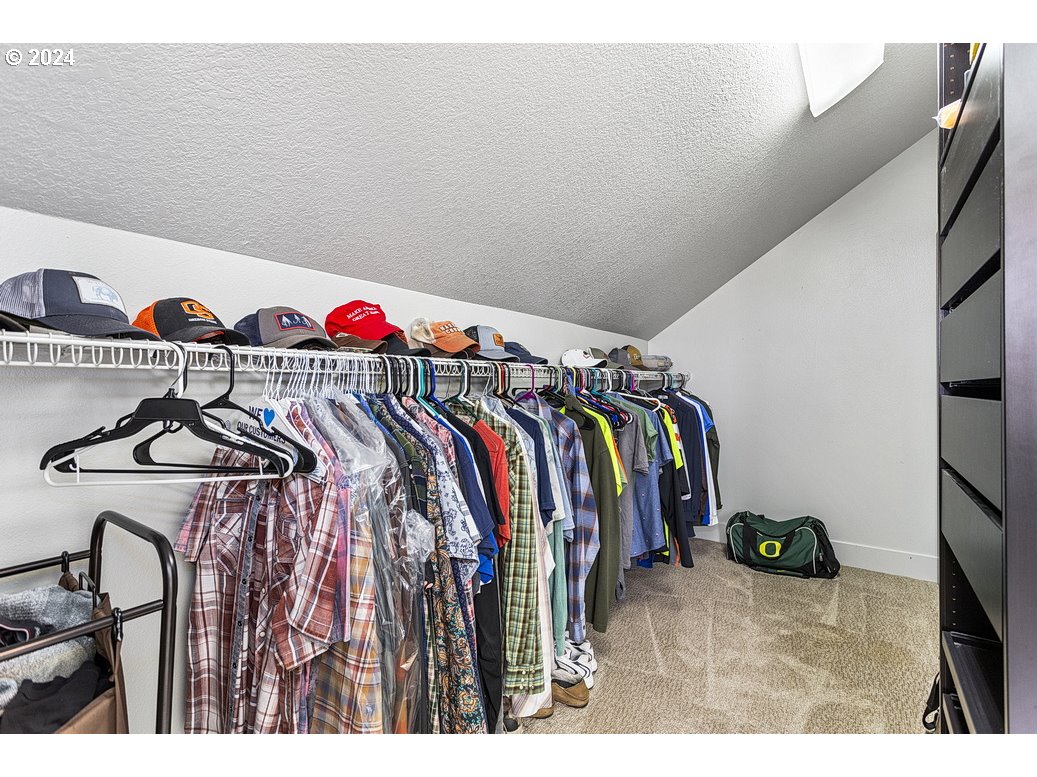 5360 Southeast Chase Road Gresham, OR 97080 - Photo 32 of 48 a view of walk in closet with clothes and shoes