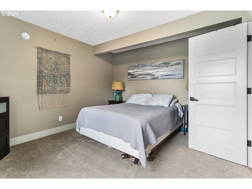 5360 Southeast Chase Road Gresham, OR 97080 - Photo 34 of 48 a bedroom with a large bed and a window