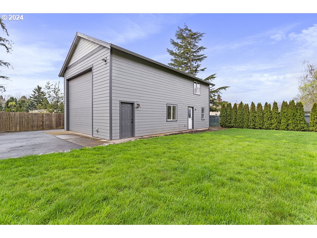 5360 Southeast Chase Road Gresham, OR 97080 - Photo 48 of 48 a view of a backyard with potted plants and large tree