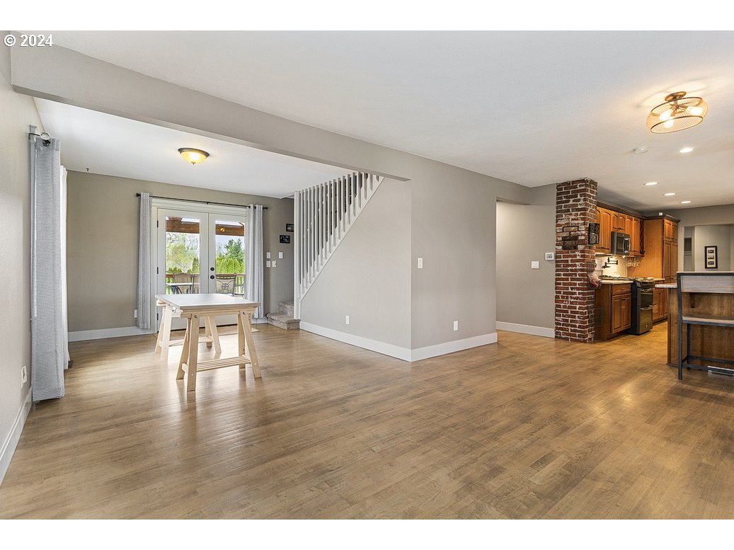 5360 Southeast Chase Road Gresham, OR 97080 - Photo 9 of 48 a view of a livingroom with furniture hardwood floor and a ceiling fan