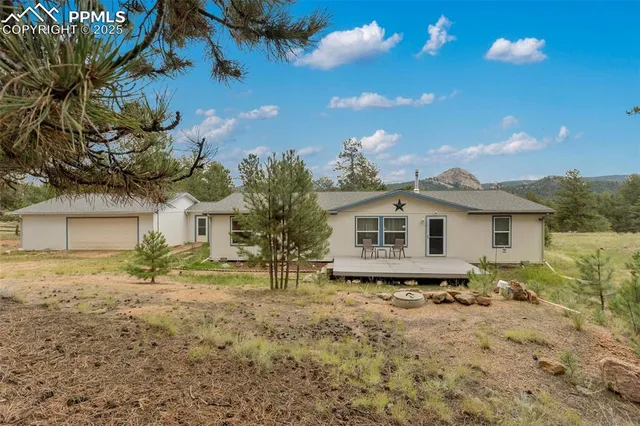 a white house that has a tree in front of it