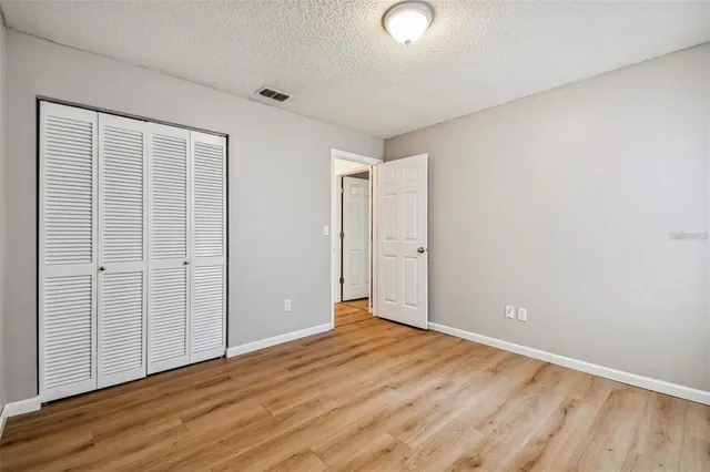 an empty room with wooden floor