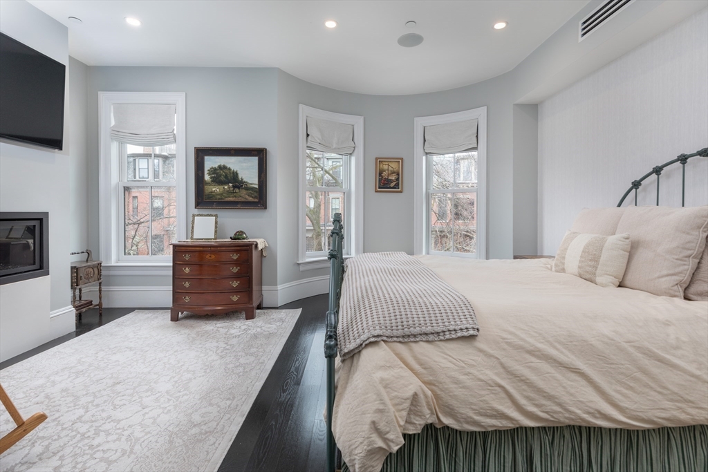 95 Appleton Street, Unit 2 Boston, MA 02116 - Photo 11 of 32 a spacious bedroom with a bed a television and a large window