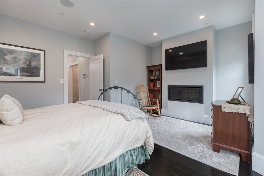 95 Appleton Street, Unit 2 Boston, MA 02116 - Photo 13 of 32 a spacious bedroom with a bed and a flat screen tv