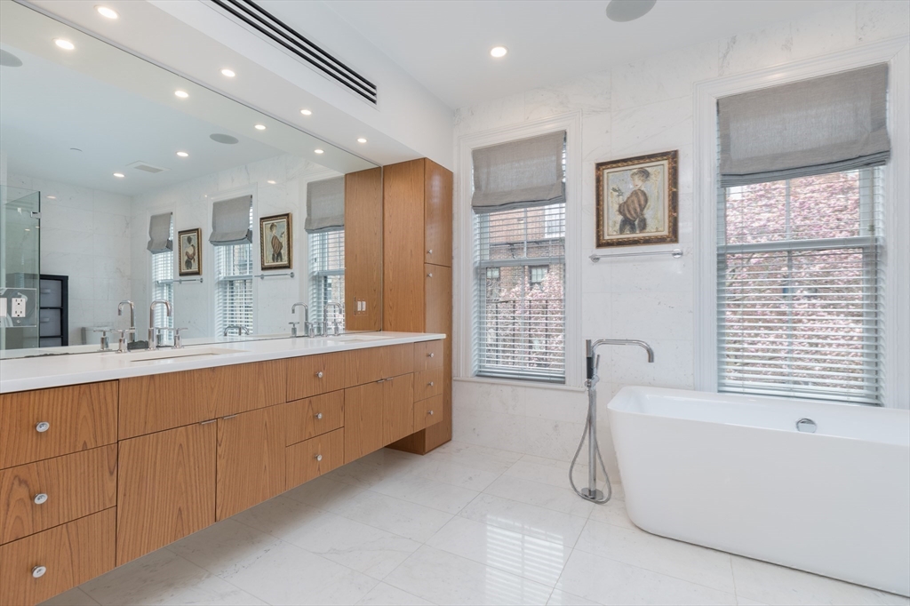 95 Appleton Street, Unit 2 Boston, MA 02116 - Photo 14 of 32 a spacious bathroom with a granite countertop tub sink shower and mirror