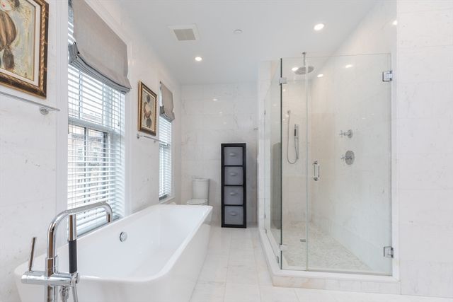 a bathroom with a bathtub and a shower