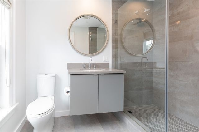 a bathroom with a toilet a sink and a mirror