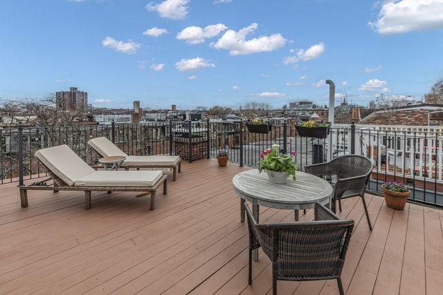 a swimming pool with outdoor seating and a potted plant