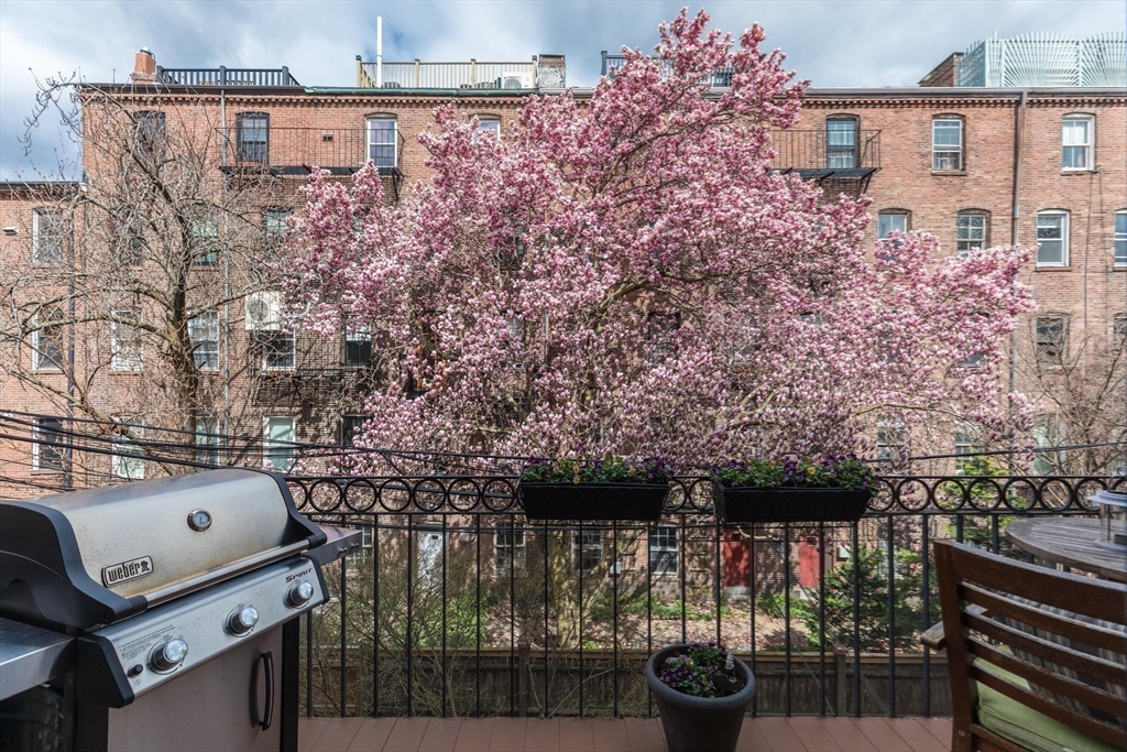 95 Appleton Street, Unit 2 Boston, MA 02116 - Photo 28 of 32 a balcony with a couple of cars parked on road