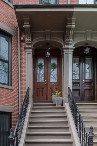 a view of a house with large windows and stairs