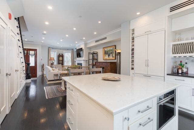 a view of kitchen with sink and refrigerator