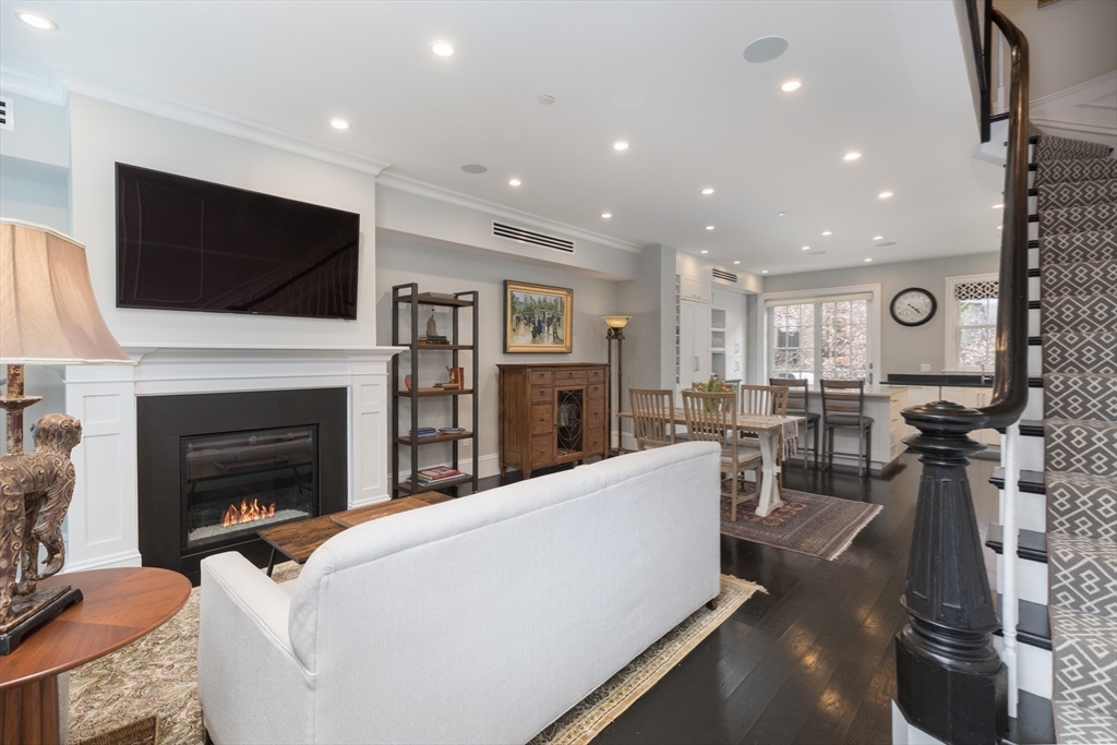 95 Appleton Street, Unit 2 Boston, MA 02116 - Photo 10 of 32 a living room with furniture a flat screen tv and a fireplace