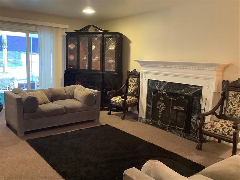 2240 Beulah Road Pittsburgh, PA 15235 - Photo 14 of 24 This large 20' X 13' den/family room is great for family gatherings - quite cozy in the winter with easy access through the sliding glass doors to the pool in the summer . The gas fireplace is framed in variegated charcoal marble. The recessed lighting gives the room a softer feel.