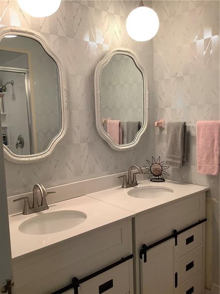 2240 Beulah Road Pittsburgh, PA 15235 - Photo 10 of 24 The master bath has been updated with a double sink vanity, dual mirrors and contemporary globe lighting