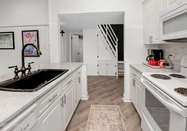 a kitchen with a sink cabinets and a stove