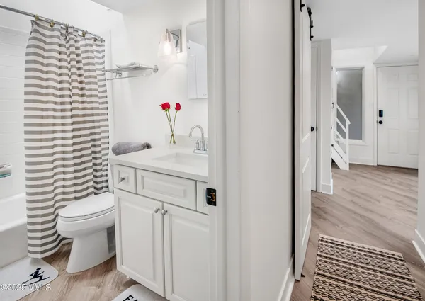 a bathroom with a sink toilet and shower