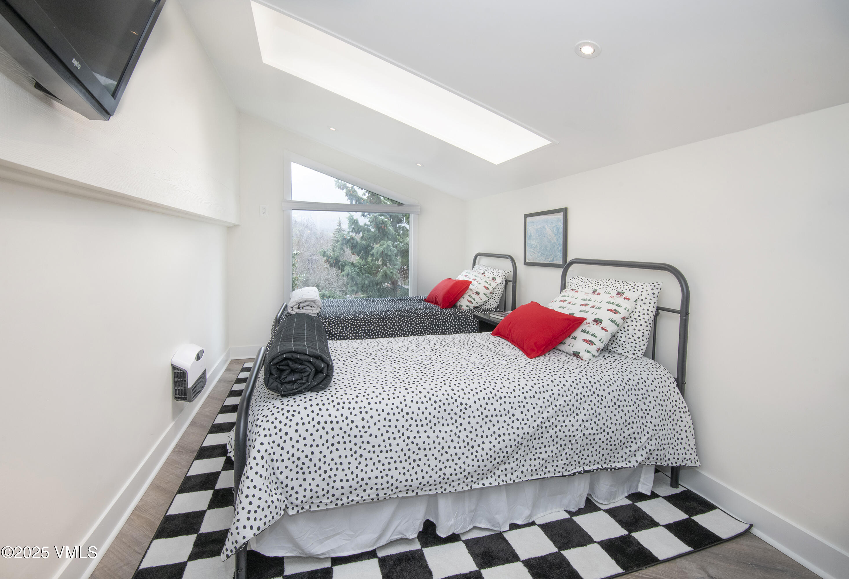 4480 Timber Falls Court, Unit 1507 Vail, CO 81657 - Photo 21 of 29 a bedroom with a bed and wooden floor