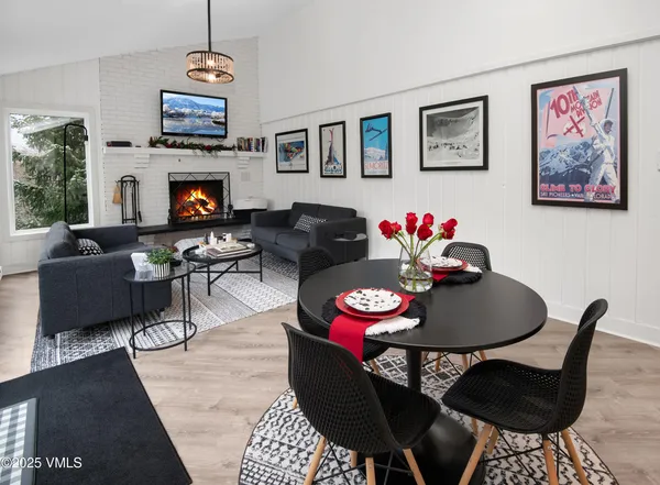 a living room with furniture a flat screen tv and a dining table