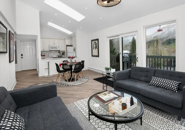 a living room with furniture and a chandelier