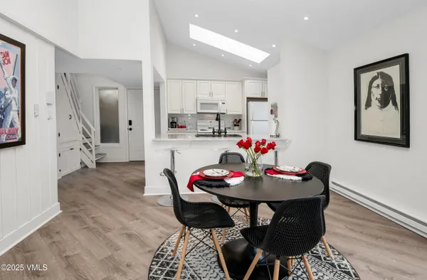 a view of a dining room with furniture and wooden floor