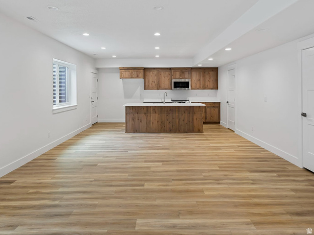 728 East Mountain Road North Ogden, UT 84414 - Photo 19 of 28 Spacious open-concept room featuring wood-finish flooring, recessed lighting, and a modern kitchen area