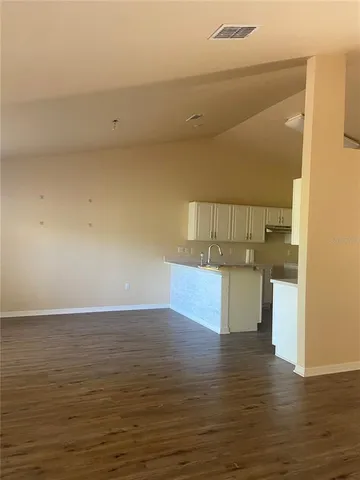 a view of storage and utility room with wooden floor