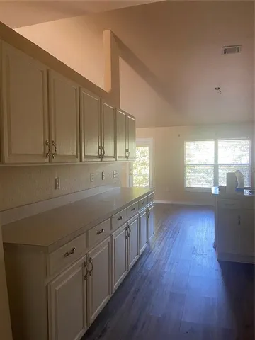 a kitchen with sink cabinets and wooden floor