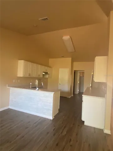 a view of a kitchen cabinets and a wooden floor