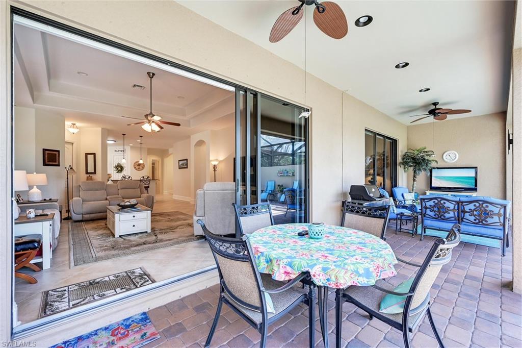 7587 Moorgate Point Way Naples, FL 34113 - Photo 14 of 47 a living room with furniture and wooden floor