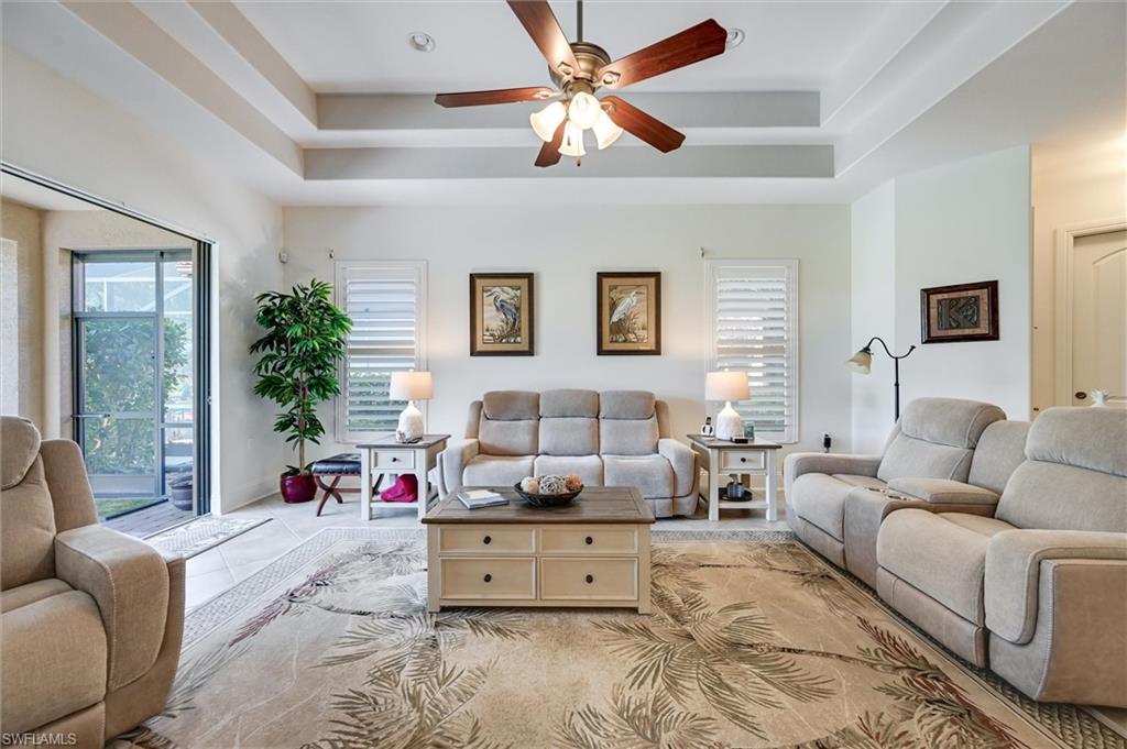 7587 Moorgate Point Way Naples, FL 34113 - Photo 16 of 47 a living room with furniture and a large window