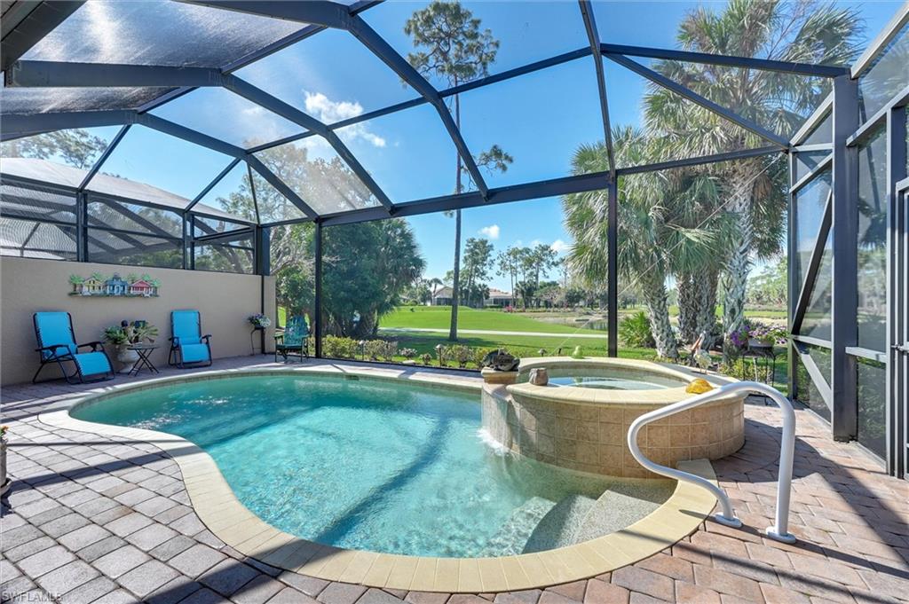 7587 Moorgate Point Way Naples, FL 34113 - Photo 2 of 47 a view of a swimming pool with a patio