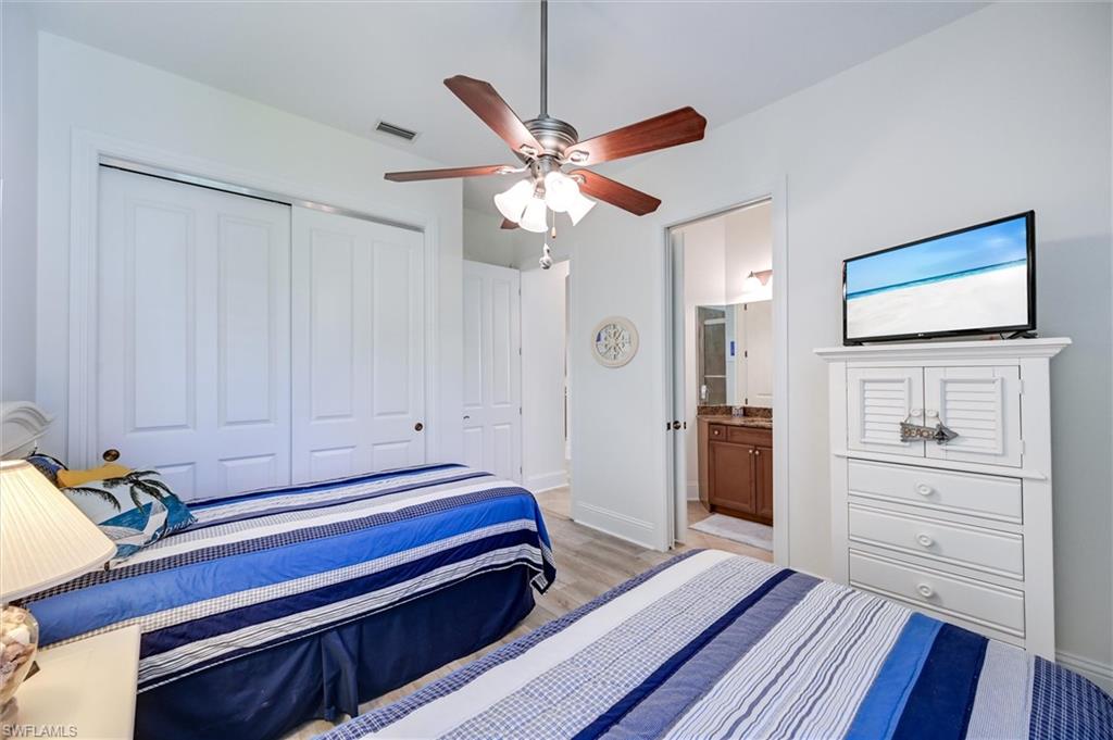 7587 Moorgate Point Way Naples, FL 34113 - Photo 36 of 47 a bedroom with a bed and a dresser