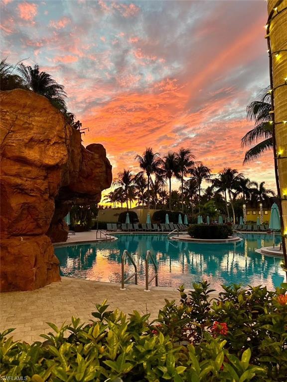 7587 Moorgate Point Way Naples, FL 34113 - Photo 46 of 47 a view of a lake with a house in the background